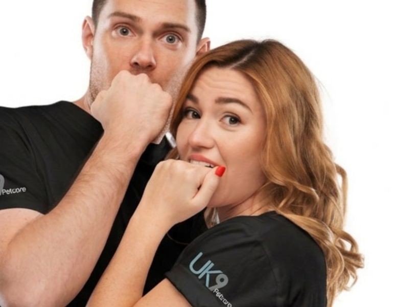 Two people wearing UK9 Petcare T-shirts